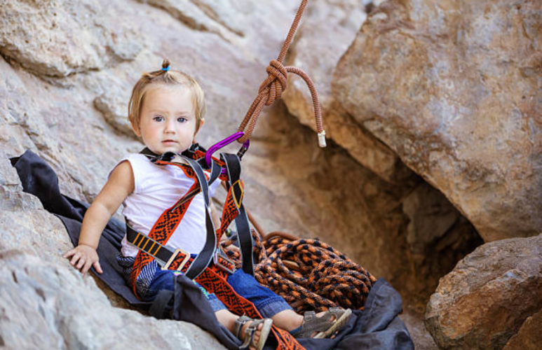 child with climbing gear